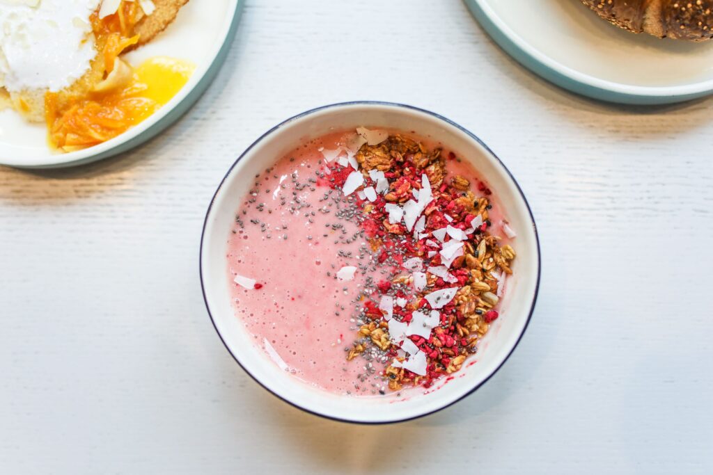 pexels-photo-3872248-3872248 Delicious pink smoothie bowl with granola, chia seeds, and coconut flakes for a healthy breakfast.